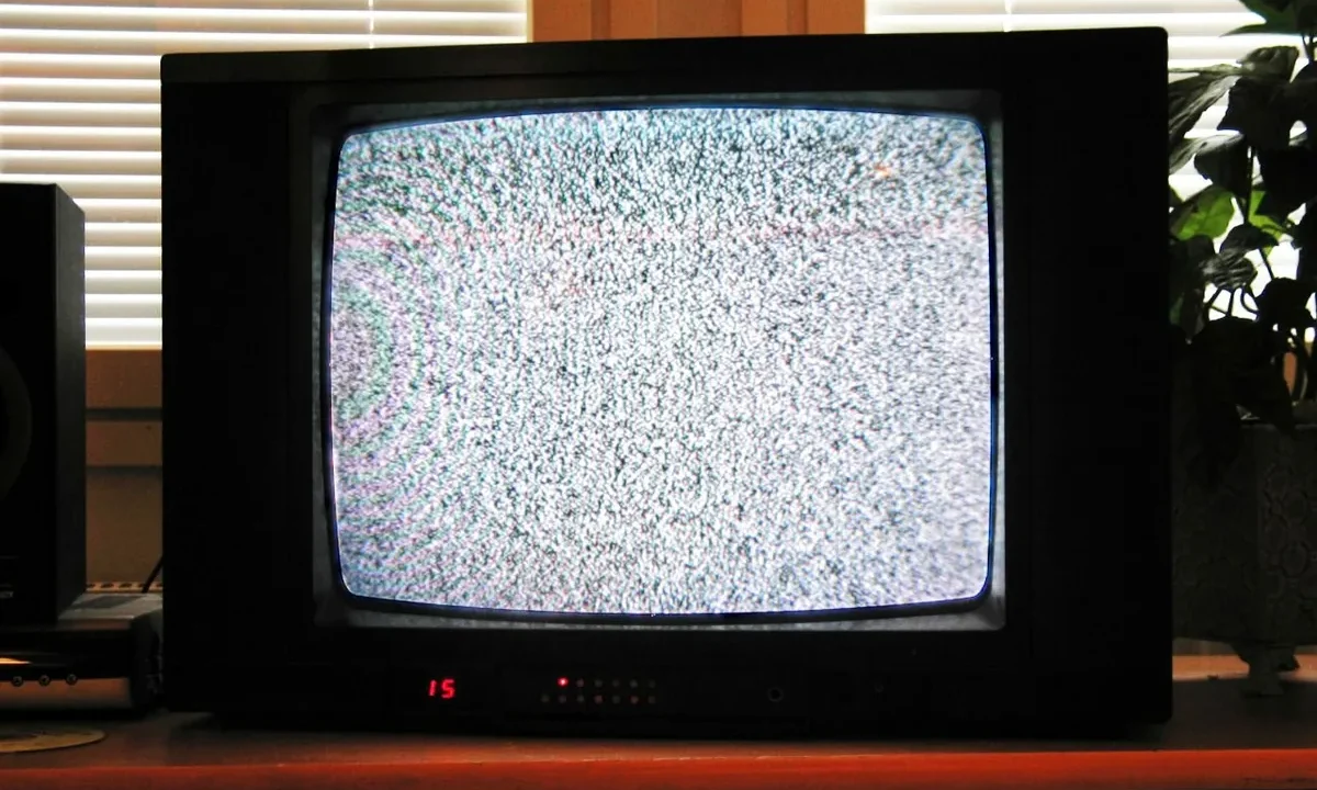Eski bir CRT televizyon ekranında parazitli, bozuk analog horror estetiği